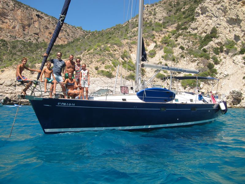 Ibiza day trips. Nice blue hull sailboat anchored in beautiful Ibiza cove